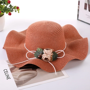 Women's wide brim straw sun hat in brick red with wave edge and floral ornament