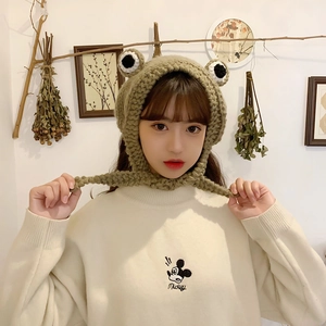 Detailed knit texture of light khaki frog earflap hat with large decorative eyes