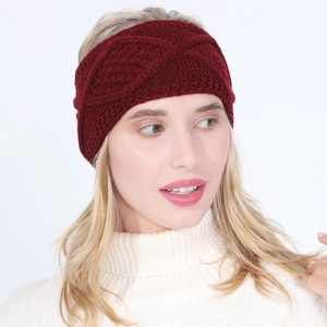 Detailed knit texture of a dark red winter cross-woven headband on a model