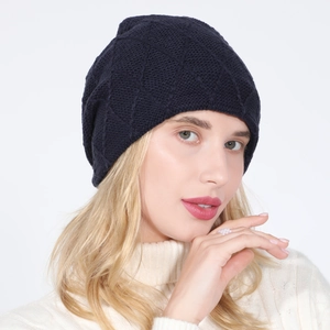 Detail of navy blue knitted beanie featuring a distinct diamond pattern texture