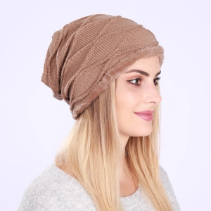 Close-up of caramel knit beanie showing textured diamond pattern and plush fleece lining