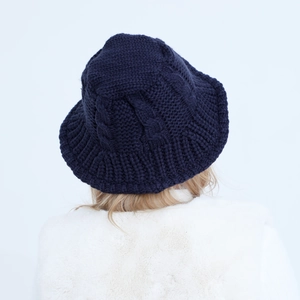 Detail view of the deep blue braided knit pattern on this warm winter bucket hat