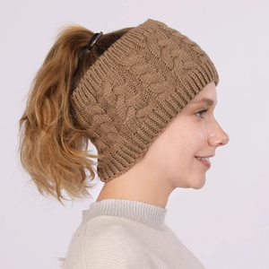 Detail of camel cable knit headband featuring an open top design for ponytails
