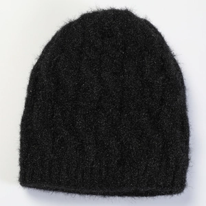 Detailed close-up showing the soft black knitted texture and fluffy wool fibers of the hat