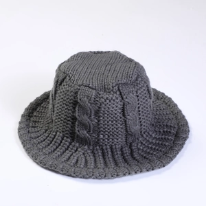 Detailed view of dark grey cable knit pattern on a warm winter fisherman bucket hat