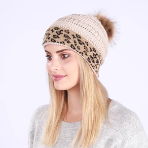 Detail of beige knit beanie featuring leopard print cuff and brown faux fur pom-pom