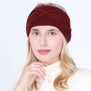 Detailed close-up of wine red cable knit headband with elegant cross-knot design
