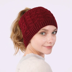 Detail of dark red cable knit ponytail headband showing thick texture and top opening