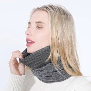Detail of dark grey ribbed knit neck warmer for winter worn by model over a white sweater