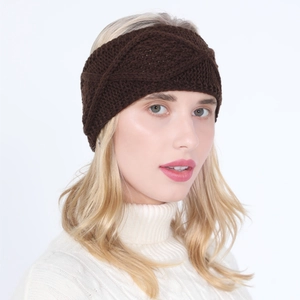 Detail of coffee brown cable knit headband on model wearing white turtleneck sweater