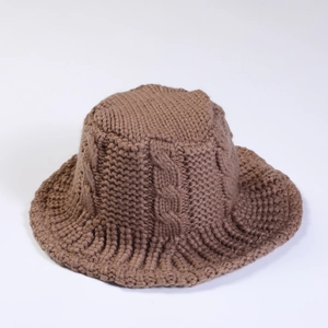 Detail view of the dark brown cable-knit texture and ribbed brim of the bucket hat