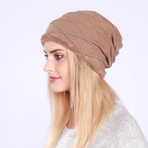 Detail of plush fleece lining and textured knit pattern on warm khaki winter beanie