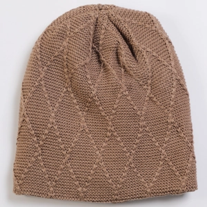 Detailed view of the diamond-patterned knit texture on a soft brown winter beanie cap