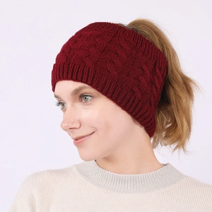 Close-up of wine red cable knit headband with ponytail hole for winter warmth