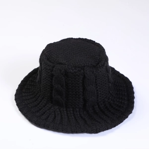 Detailed view of black cable-knit texture on a warm winter bucket hat for women