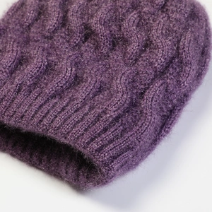 Close-up of deep purple cable knit texture and soft lining on women's winter beret