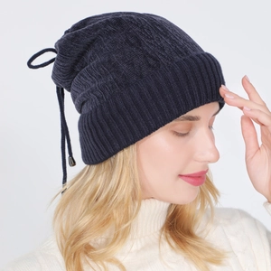 Detailed knit texture and drawstring bow on navy blue thermal winter beanie hat