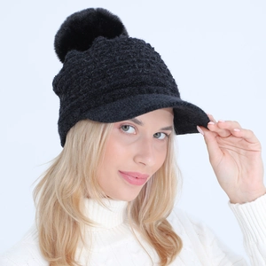Women's black knit winter visor hat with plush pompom and fleece lining for warmth