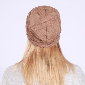 Detail view of camel knit beanie featuring unique star shaped textured stitching pattern