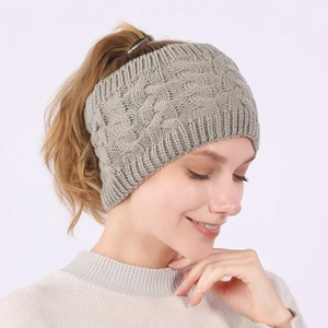Detail of light grey cable knit headband with thick twist pattern and ribbed edges
