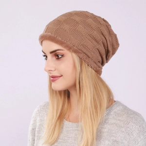 Macro detail of brown checkered knit beanie showing warm faux fur lining texture
