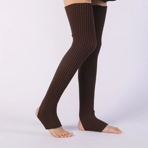 Detail of dark brown ribbed knit over-knee leg warmers with a stirrup design for yoga