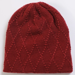 Detail view of the burgundy knit beanie featuring a distinct diamond pattern texture