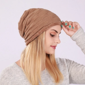 Detail of brown knitted beanie showing checkered texture and soft fleece lining for winter