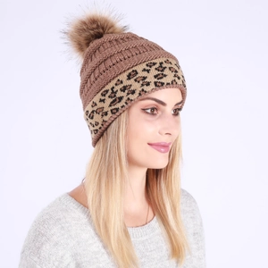Detailed knit texture and brown faux fur pompom on leopard print winter beanie