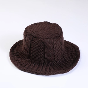 Detailed knit texture of dark brown twist-pattern bucket hat for winter warmth