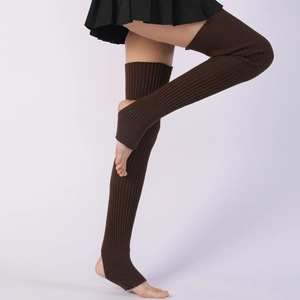Macro view of dark brown knitted leg warmers with stirrups and ribbed texture detail