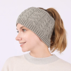 Close-up of light grey cable knit headband for women with warm winter texture