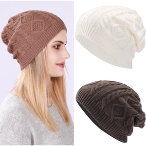 Detailed cable knit pattern on warm winter beanies in beige and brown shades
