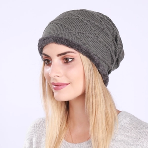 Close-up of olive green knitted beanie with thick grey fleece lining for winter warmth