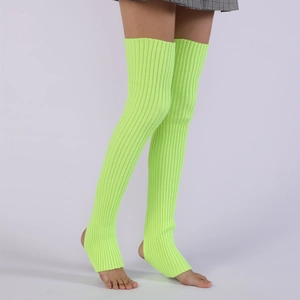 Macro shot of neon green ribbed knit leg warmers with over-knee length and stirrup design