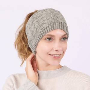 Close-up of grey cable knit headband for women with a warm and soft wool texture