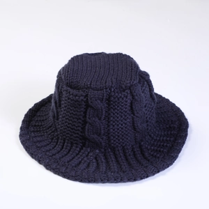 Detailed view of dark blue chunky cable knit pattern on a warm winter bucket hat