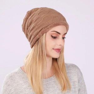 Close-up of brown knitted slouchy beanie featuring a warm faux fur lining and grid texture