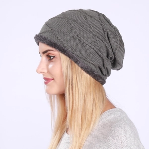 Detail of dark grey knit beanie featuring a thick fleece lining and ribbed texture
