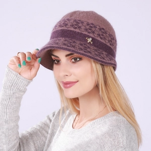 Detail view of purple knit beanie with floral jacquard pattern and gold butterfly clip