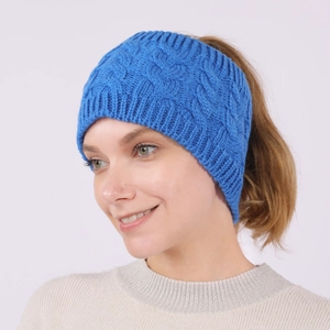 Detail of blue cable knit headband showing the thick texture and ponytail opening