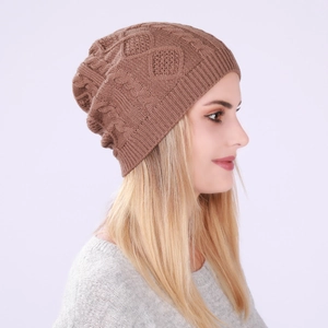Detailed view of coffee brown knit beanie featuring diamond cable patterns and slouchy fit