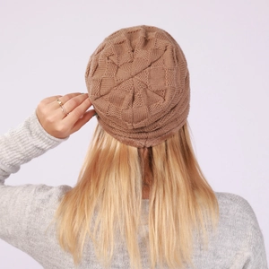Detail of warm brown knit beanie with plush fleece lining and textured diamond pattern