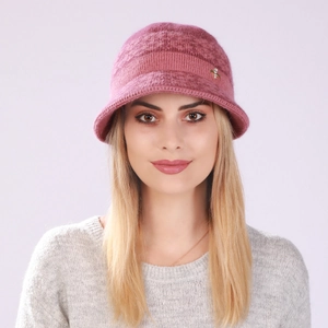 Close-up of knit fisherman hat texture in dusty pink with small gold metal ornament
