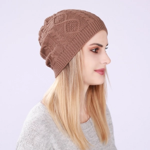 Close-up of brown knitted beanie with diamond weave and cable patterns for winter