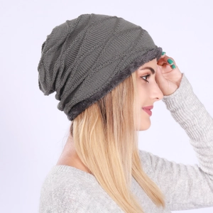 Detailed view of dark grey knitted hat with warm fleece lining and geometric pattern