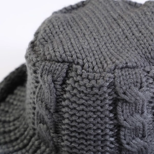 Close-up of thick cable knit texture and ribbed edge on dark grey winter bucket hat
