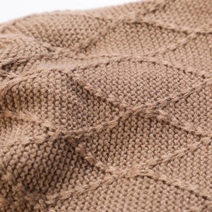 Close-up of brown knit beanie featuring diamond lattice pattern and thick texture