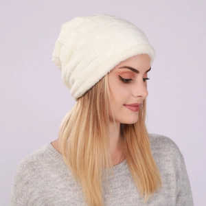 Detail view of cream knit beanie with textured fleece lining and fluffy white trim detail