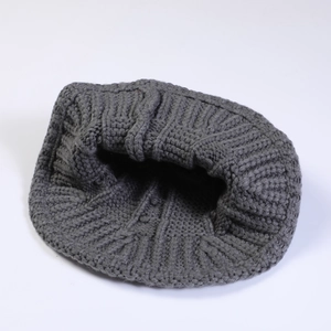 Detailed view of dark grey chunky knit texture on a stylish winter bucket hat